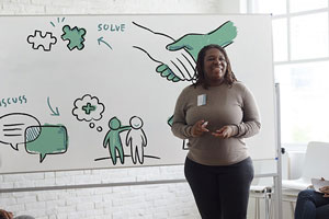 Woman presenting at white board