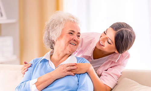 Woman comforting an elderly woman 