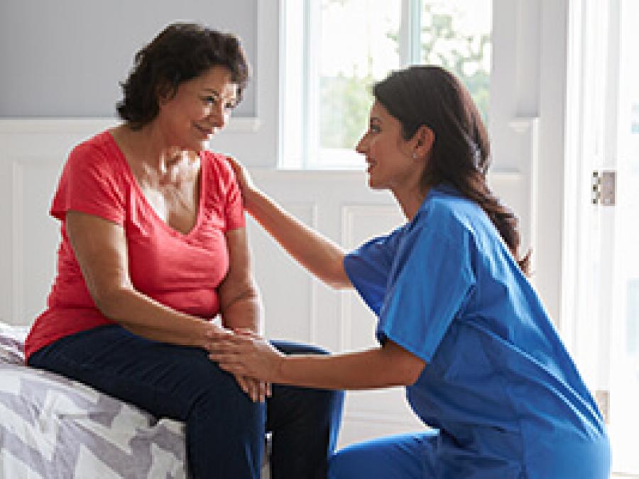 Nurse comforting an older woman