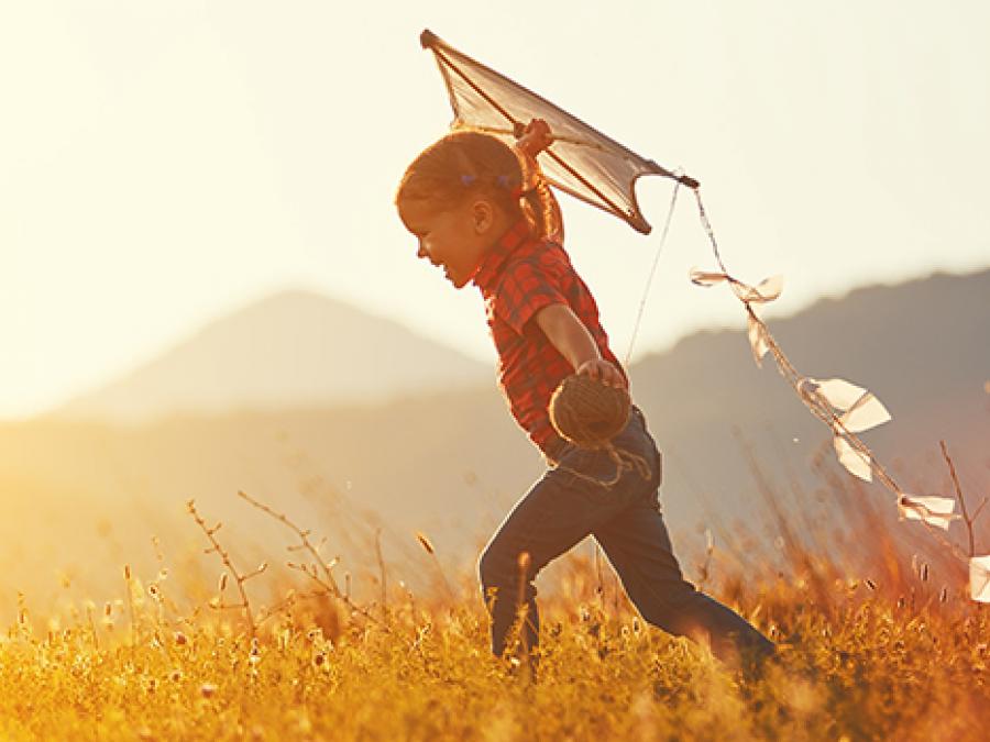 a little boy playing with a kite