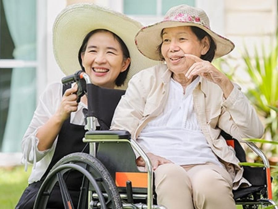 Elderly woman in a wheelchair accompanied by another woman