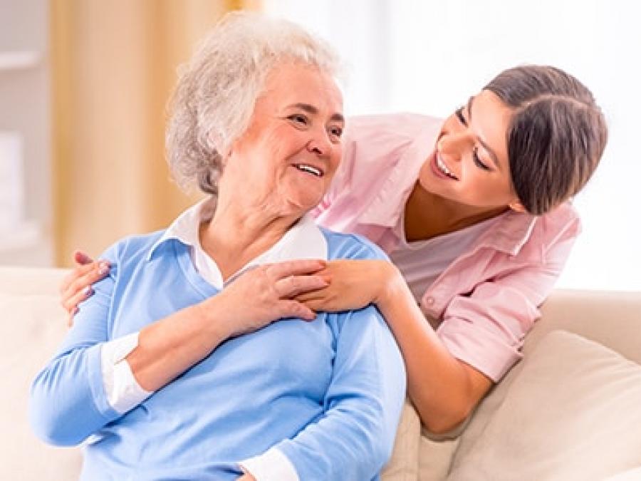 Woman comforting an elderly woman