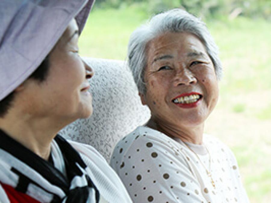 Two senior women chatting and smiling